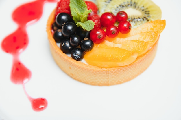 Delicious cheesecake with berries on table close up