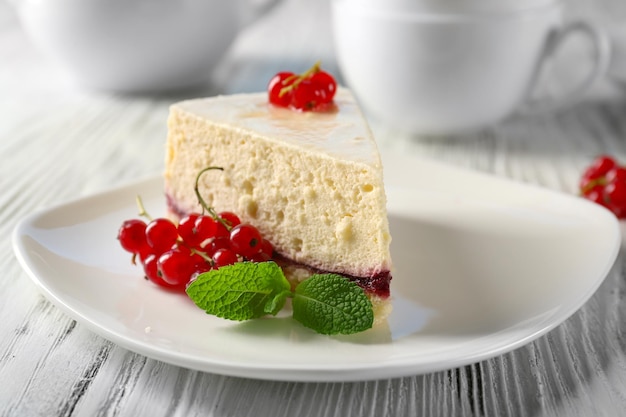 Delicious cheesecake with berries on table close up