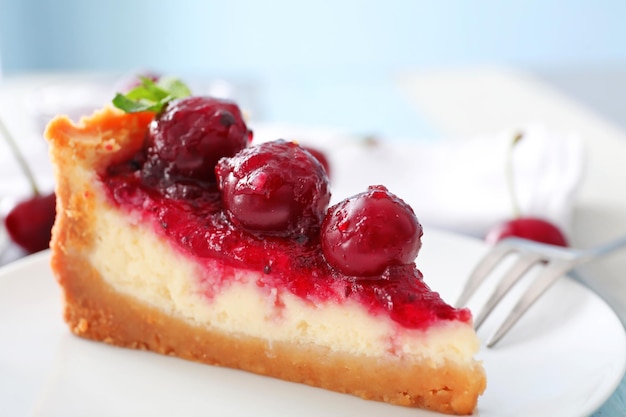 Delicious cheesecake with cherries on plate closeup