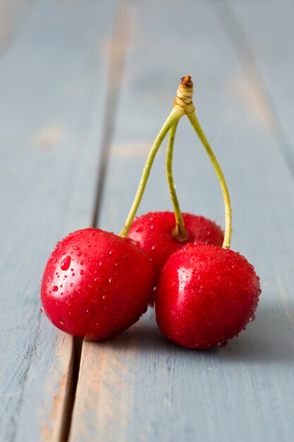 Delicious cherries on a blue wooden table