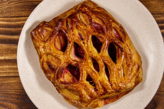 Delicious cherry strudel on wooden table. Top view