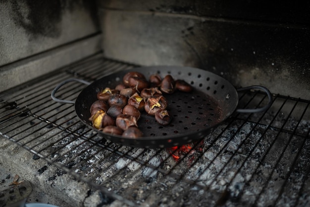 Delicious chestnuts roasting above embers