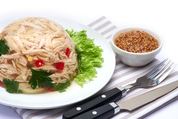 Delicious chicken aspic on a plate isolated on white background