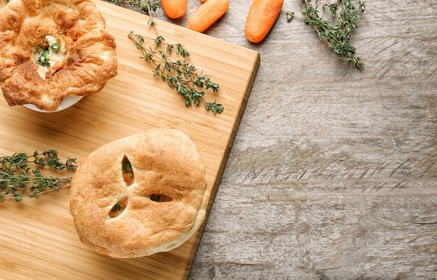 Delicious chicken pot pie on wooden board