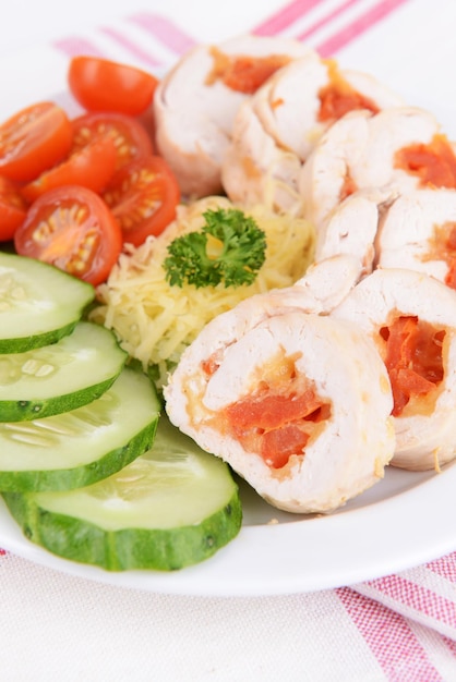 Delicious chicken roll on plate on table closeup