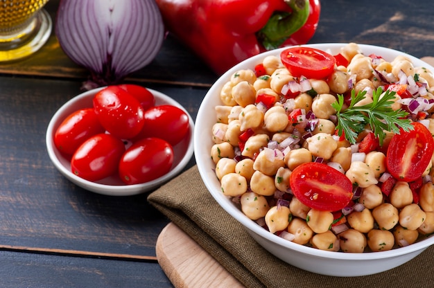 Delicious chickpea salad with tomatoes, onions, peppers and parsley
