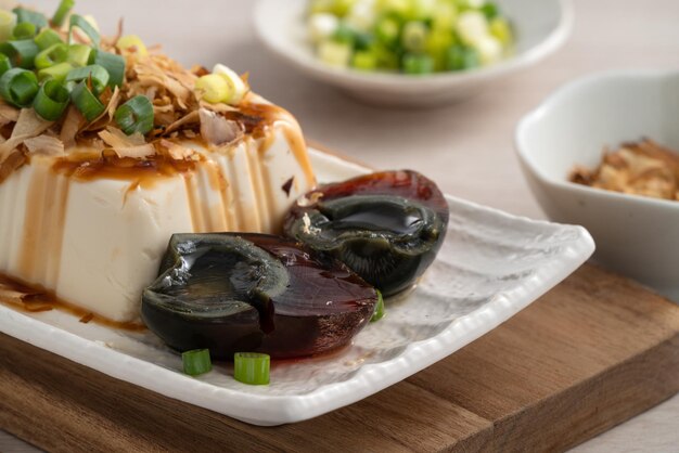Delicious Chilled tofu and century egg with soy sauce and bonito flakes