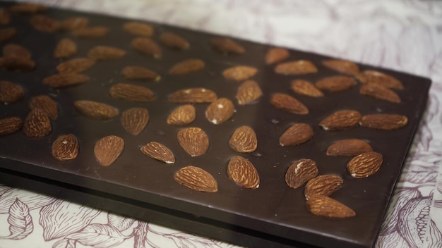 Delicious chocolate bars with nuts prepared from dark and milk chocolate Chocolate square tiles close up Sweets on the window of the store