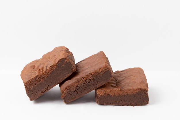 Delicious chocolate brownies on white background.