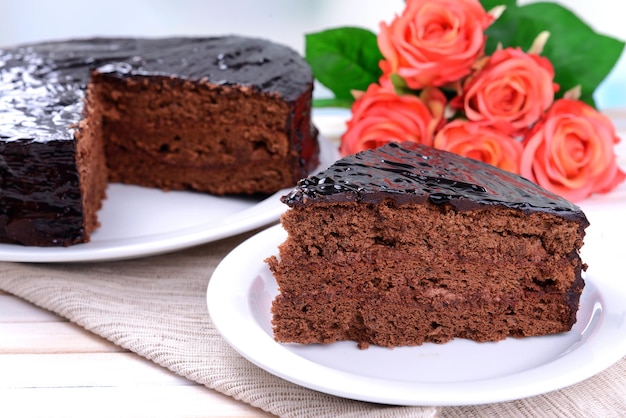 Delicious chocolate cake on plate on table close-up