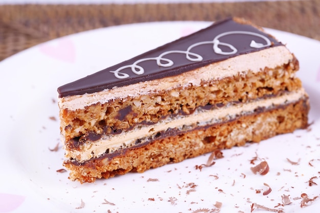 Delicious chocolate cake on plate on table close-up