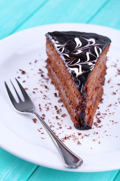 Delicious chocolate cake on plate on table close-up