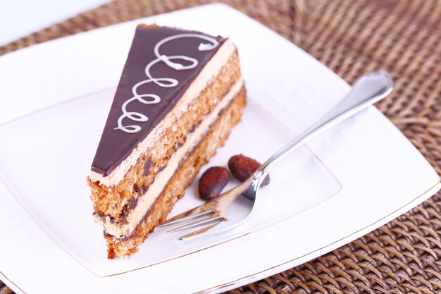 Delicious chocolate cake on plate on table close-up