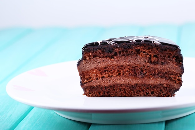 Delicious chocolate cake on plate on table close-up