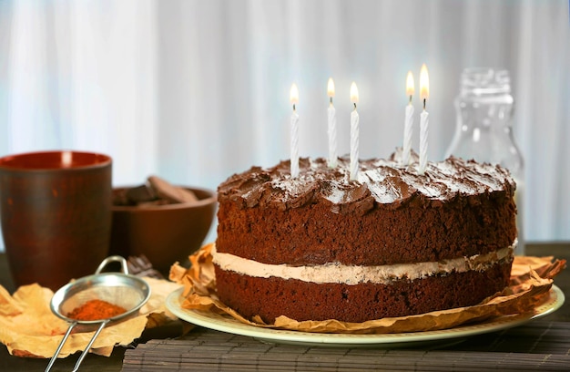 Delicious chocolate cake on table on light background