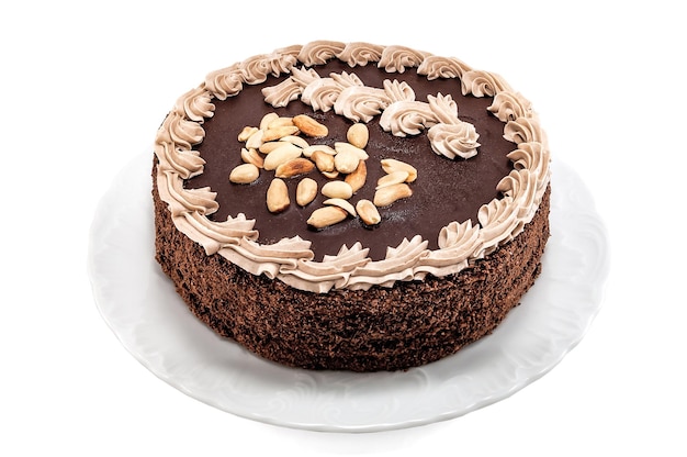 Delicious chocolate cake with peanuts on white background