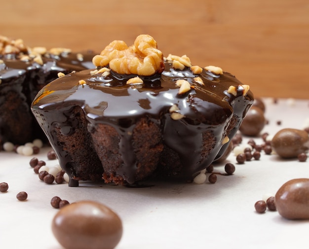 Delicious chocolate candie with nuts  on the top under the white table