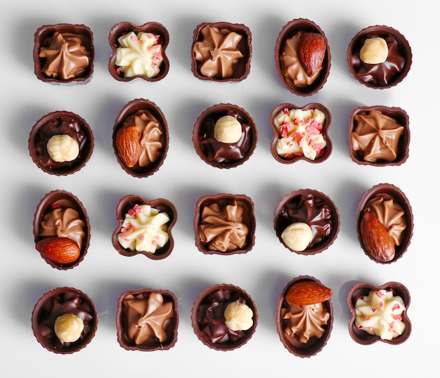 Delicious chocolate candies on white background