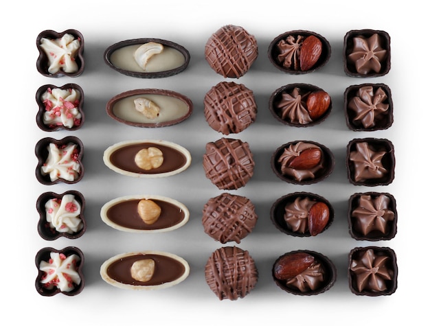 Delicious chocolate candies on white background