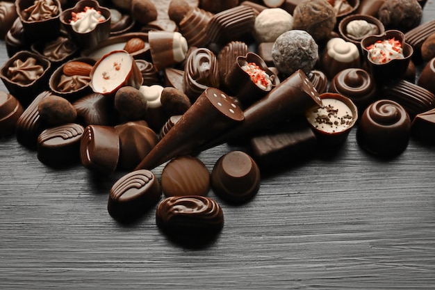 Delicious chocolate candies on wooden background