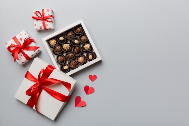 Delicious chocolate pralines in red box for Valentine's Day Heart shaped box of chocolates top view with copy space