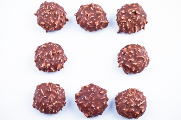 Delicious chocolate pralines over white background.