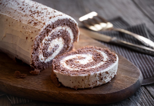 Delicious chocolate roll cake with white cream homemade baked dessert