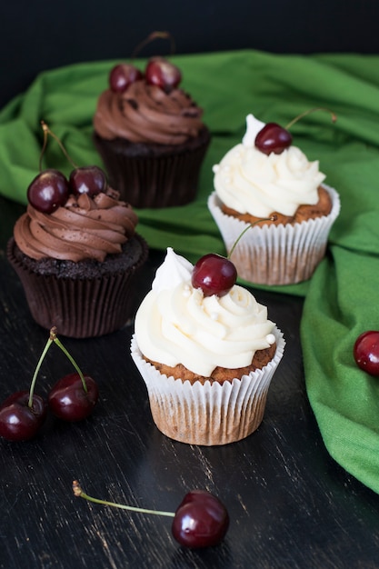 Delicious chocolate and vanilla cupcakes with cherries