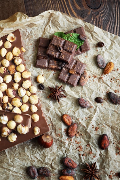 Delicious chocolates with spices on table closeup