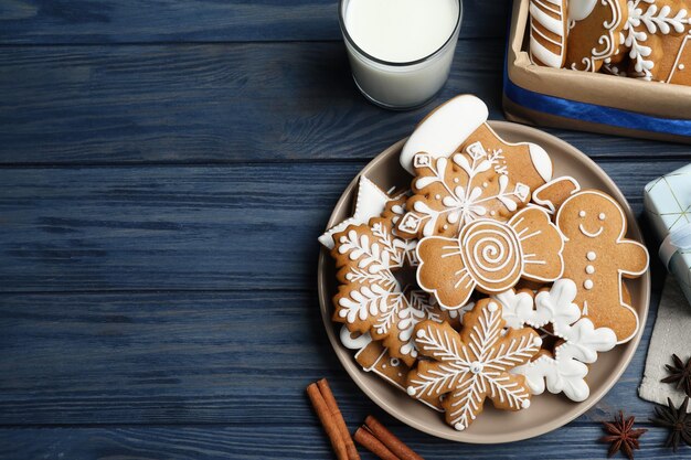 Delicious Christmas cookies on blue wooden table flat lay Space for text