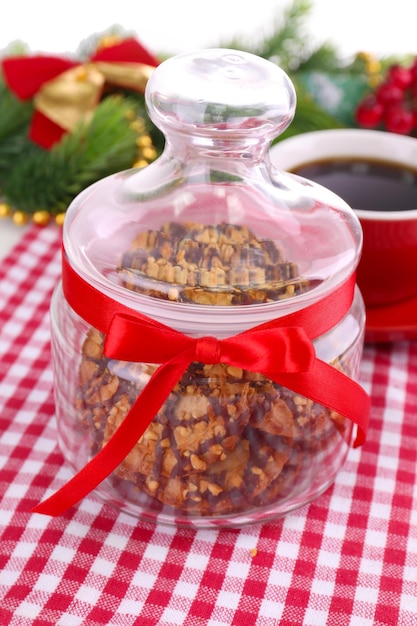 Delicious Christmas cookies in jar on table close-up