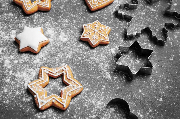 Delicious Christmas cookies with scattered powdered sugar on gray surface