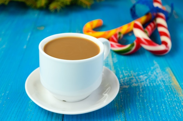 Delicious Christmas lollipops with a cup of coffee