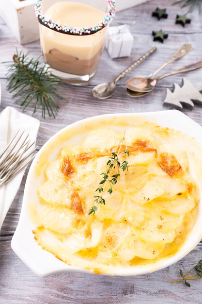 Delicious Christmas themed dinner table with potato gratin