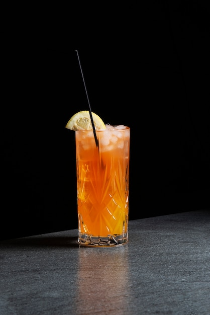 delicious cocktail glass with straw and lime