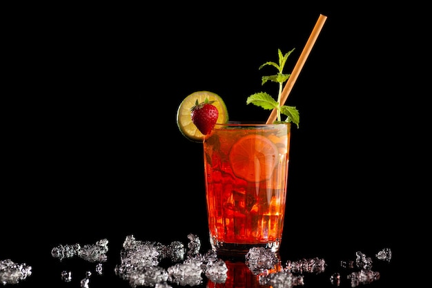 Delicious cocktail Strawberry Mojito with lemon on black wall