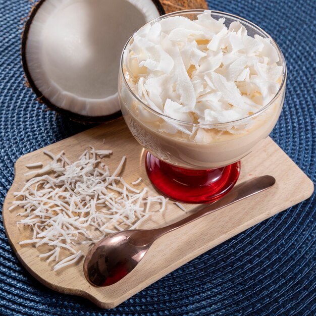 Delicious coconut mousse in glass cup.