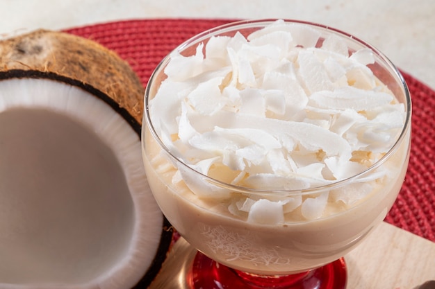 Delicious coconut mousse in glass cup.