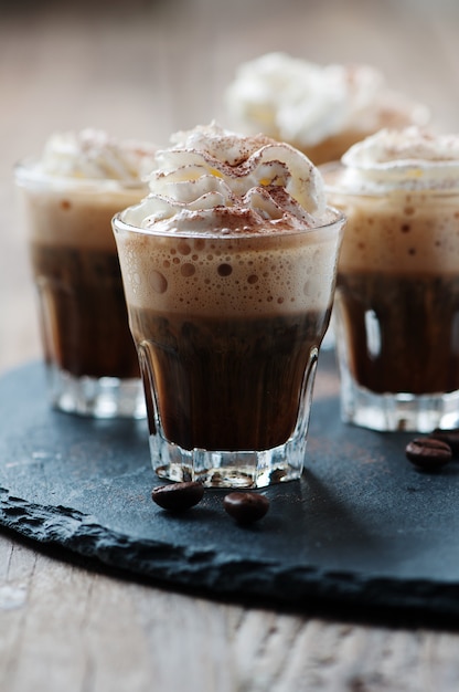 Delicious coffee with cream and cocoa