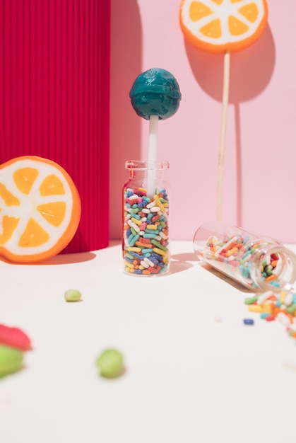 Delicious colorful candies on red and pastel pink background Close up