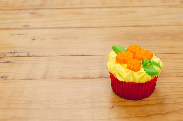 Delicious and colorful cupcake decorated with cream cheese frosting and fondant for Halloween