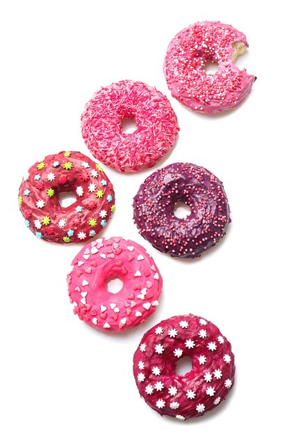 Delicious colorful donuts on white background