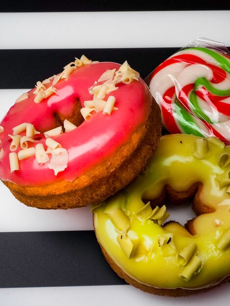 Delicious colorful donuts with sweet color lollipop