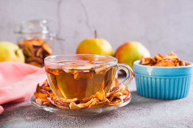 Delicious compote of aromatic dried apples in a cup on the table