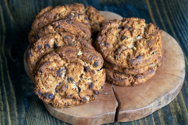 Delicious cookies with pieces of chocolate on the table