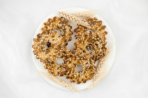 Delicious cookies with sesame seeds and flax baking according to homemade recipes on a plate