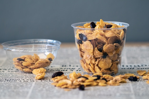 Delicious cornflakes and raisins on glasses