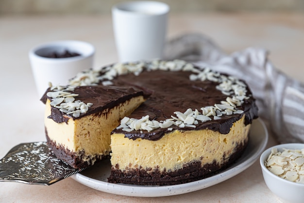 Delicious creamy cheesecake decorated with chocolate glaze and almond No bake mousse dessert