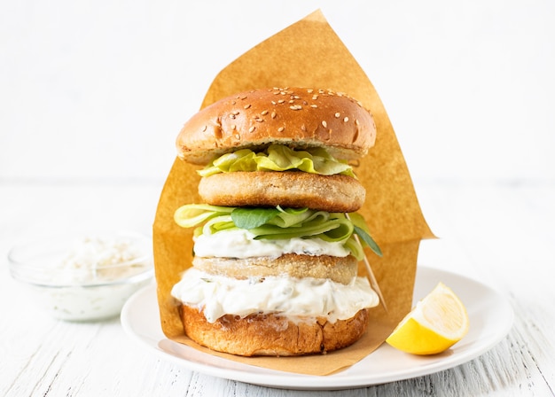 Delicious crispy fish burger with greek yogurt