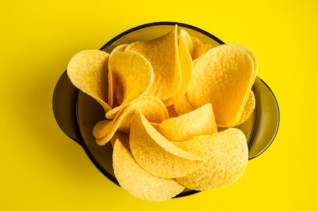 Delicious crispy potato chips in a bowl